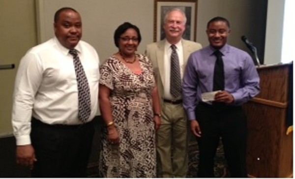 In June, Keon Hawthorne (r), a mechanical engineering student at Alabama A&M University, receives a scholarship from Michael Schexnayder (2nd from r), chapter president, while Hawthorne's parents Keith and Mary stand by.